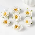 Macro detail of vintage white silk rose heads with yellow centers for DIY crafts - White