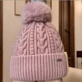 Cozy dusty pink cable knit beanie featuring a large fluffy faux fur pom-pom for winter - One Size / Pink