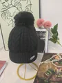 Classic black winter cable-knit beanie featuring a large faux fur pom-pom and pearl logo - One Size / Black