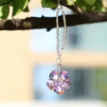 Floral iridescent crystal suncatcher hanging from a tree branch in natural light - Double Layer Petal (409) / Phantom Purple