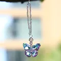 Close-up of a colorful faceted crystal butterfly suncatcher pendant hanging outdoors. - 15cm / Pink Purple Butterfly