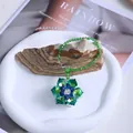 Detail view of green crystal flower suncatcher for home and car decor. - Green Flower