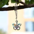 Detail view of an iridescent crystal butterfly sun catcher hanging on a tree branch. - 15cm / Phantom Purple Butterfly