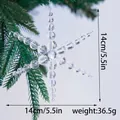 Detailed view of an acrylic beaded snowflake Christmas tree ornament on a pine branch - Clear White Snowflake Style B