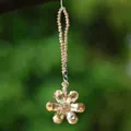 Close-up of champagne crystal flower suncatcher with faceted prism for car or home - Crystal Flower Pendant / Champagne