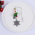 Macro view of Christmas snowflake hanging ornament featuring red and green bells and beads - Snowflake Bell Pendant