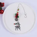 Close-up of a festive silver reindeer Christmas hanging ornament with colorful beads - Reindeer Bell Pendant