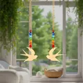 Beautiful detail view of a bird sun catcher featuring rainbow crystal beads and gold pendant - Flying Bird / Two-Piece Set / Gold