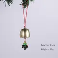 Christmas metal bell ornament with colorful tree charm hanging from pine branch - Christmas Tree Bell