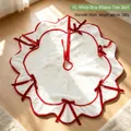 White plush Christmas tree skirt with red ribbon bows and wavy edge design, 90cm diameter. - 90cm / White