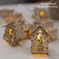 Wooden Christmas house string lights with Santa Claus cutout for festive holiday decor - Natural Wood House Santa Style