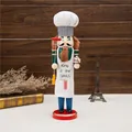 Detailed view of the 38cm chef nutcracker soldier puppet with King of Grill apron. - 38cm / Green