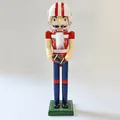 Detailed view of a hand-painted wooden football nutcracker figurine holding a rugby ball - Football Style (SB58592) / H38cm Base Diameter 9cm