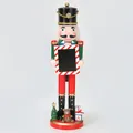 Close-up of a 38cm Christmas wooden nutcracker soldier holding a mini photo frame - Green