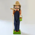 Detailed view of wooden gardener nutcracker figure wearing straw hat and denim overalls - Gardener / 38cm