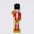 Detailed view of a 25cm red and gold Christmas nutcracker soldier holding an axe. - 25cm / Axe