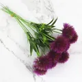 Gedetailleerde weergave van paarse kunstmatige paardenbloem bloemen op witte marmeren achtergrond - Jade Paars