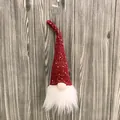 Festive red knitted Christmas gnome ornament with sparkling sequins and long white faux fur beard - Red