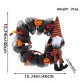 Halloween wreath with long-legged gnome, black mesh, and pumpkins for spooky door decor - Black