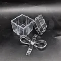 Exploded view of transparent PS plastic gift box showing base, lid, and bow detail - Square Box (38g)