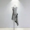 Detailed view of a grey sleeveless asymmetrical tank dress with tie-waist design. - S / Dresses / Gray