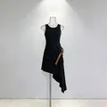 Detail view of a black sleeveless asymmetric dress with a brown belt and ruched side. - S / Dresses / Black