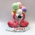Detailed macro shot of a cute pink flamingo couple car ornament with colorful balloons - Pink Flamingo