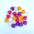 Colorful diamond-shaped reusable plastic ice cubes scattered on a white surface. - Diamond Shape / Set of 24 / Mixed Colors