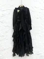 Elegant black chiffon maxi dress featuring ruffles, a bow tie neck, and gold brooch detail - S / Dresses / Black