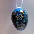 Detail view of a blue Easter decorative egg with intricate folk art floral patterns - European Folk Blue Style (Style 2)