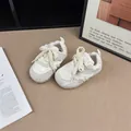 Close-up of girl's white sneakers with delicate bow and pearl details - 22 / Beige