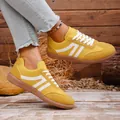 Vintage yellow German Army Trainers featuring white stripes and rubber gum sole for women - Bright yellow