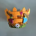 Detailopname van een oranje vilten paasmandje met konijntjes en hartjesversiering. - Oranje Konijn
