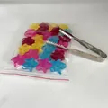 Detail view of colorful star-shaped reusable plastic ice cubes and metal tongs - Star 24pcs with Clip