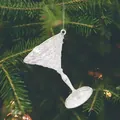 Detailed view of clear acrylic martini glass ornament on green pine tree branch - Transparent Acrylic Wine Glass