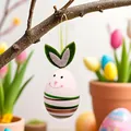 Detailed view of a bunny-shaped Easter egg pendant hanging on a natural branch. - Striped Rabbit Style (Style 2)
