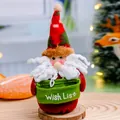 Handmade felt Santa Claus doll Christmas decoration holding a green Wish List basket - Santa Claus