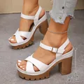 Detail showing white platform sandals with a 10.5cm chunky high heel and straps. - 35 / White
