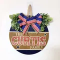 Patriotic Independence Day round wooden door sign with American flag bow and greenery - Family Surname Style (Style 2)