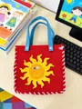 Red children's DIY felt bag with yellow sun motif on a creative workspace - Sun Bag
