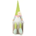 Detail of a green plush gnome doll sitting on a wooden block with a flower - Grass Green