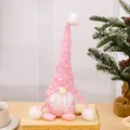 Pink knitted Christmas gnome plush doll on wooden tray for holiday decoration - Pink