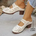Detail view of women's hollow-out clogs showing 6.8cm chunky heel height - White