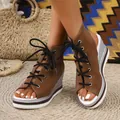 Detail of brown peep-toe wedge sandals with black laces and silver woven platform sole. - 38 / Dark Brown
