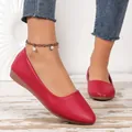 Detailed shot of elegant red pointed toe flat shoes featuring premium leather texture - Burgundy