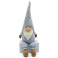 Detail shot of a gray plush gnome doll with long beard and striped clothes on white seat - Sitting Style