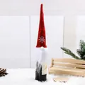 Festive red Christmas gnome wine bottle cover featuring white snowflake embroidery detail - Burgundy