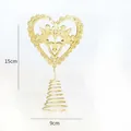 Detail view of gold glitter heart-shaped Christmas tree topper with angel design - Gold Angel Heart