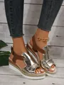 Detail of metallic gold peep-toe wedge sandals with brown buckle strap for women. - Gold