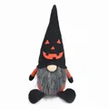Detail showing a Halloween gnome plush featuring an orange pumpkin face and long gray beard - Black Pumpkin Hat Gnome / Black